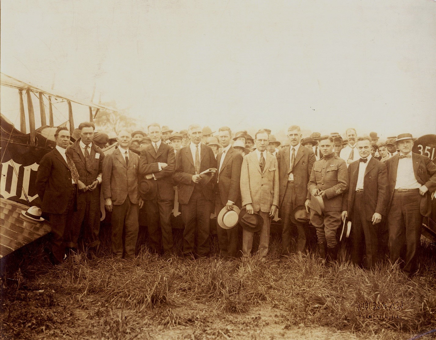 People assembled after the plane landed, Isaac Kuhn is fifth from the right, 1919.