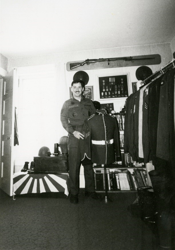 Gary Alstrand holding a uniform