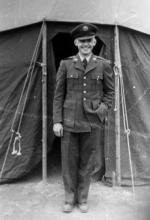 Donald O. Weckhorst dressed in military uniform in front of tent, 1951