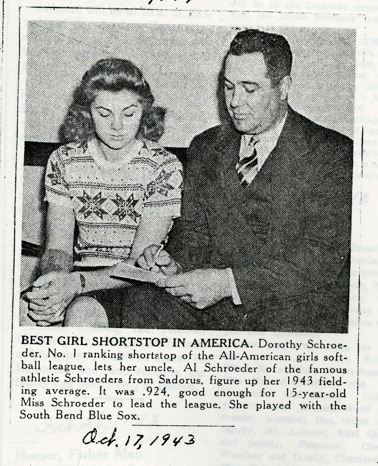 Dorothy Schroeder (15) sitting beside her uncle Al Schroeder as her calculates her 1943 field average for the South Bend Blue Sox.  
