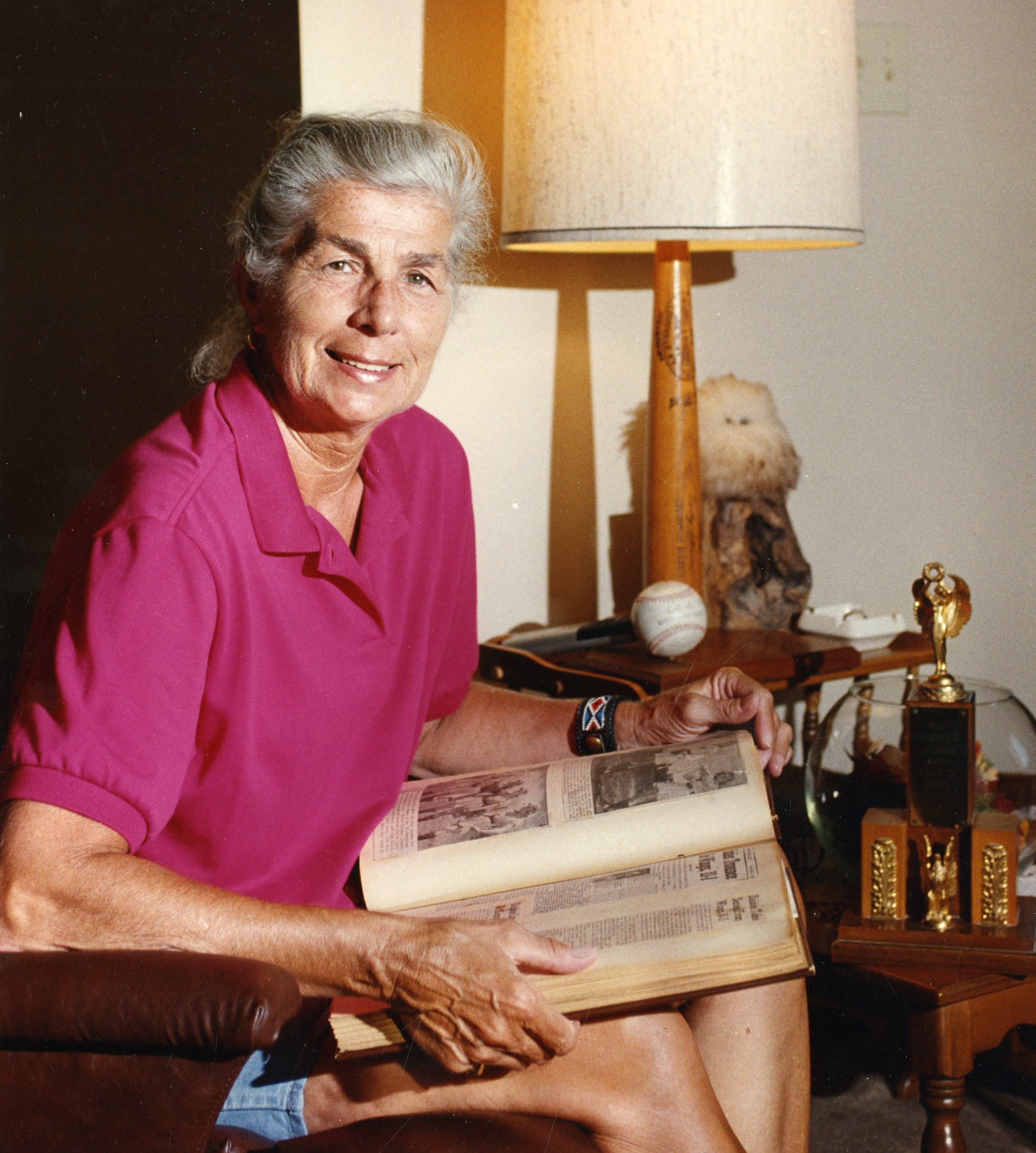 Dorothy Schroeder looks through a scrapbook in a 1991 photo. News-Gazette, December 9, 1996