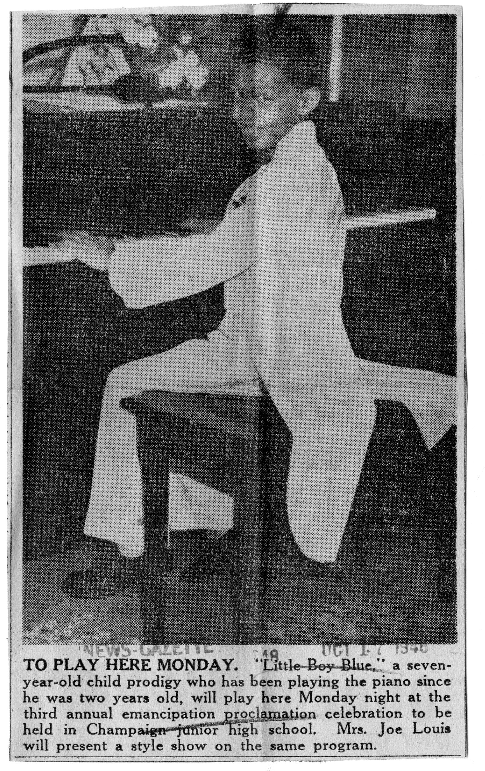 Photo of seven year old sitting at a piano. Dubbed "Little Boy Boy" he was a child prodigy who played the blues and preformed at Champaign Junior High School. News-Gazette, 17 October 1948.