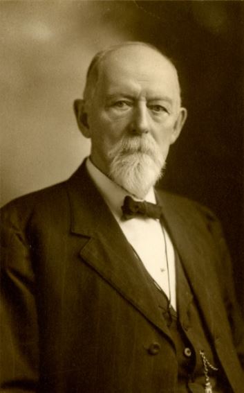 Black and white photograph of J.O. Cunningham from the waist up.