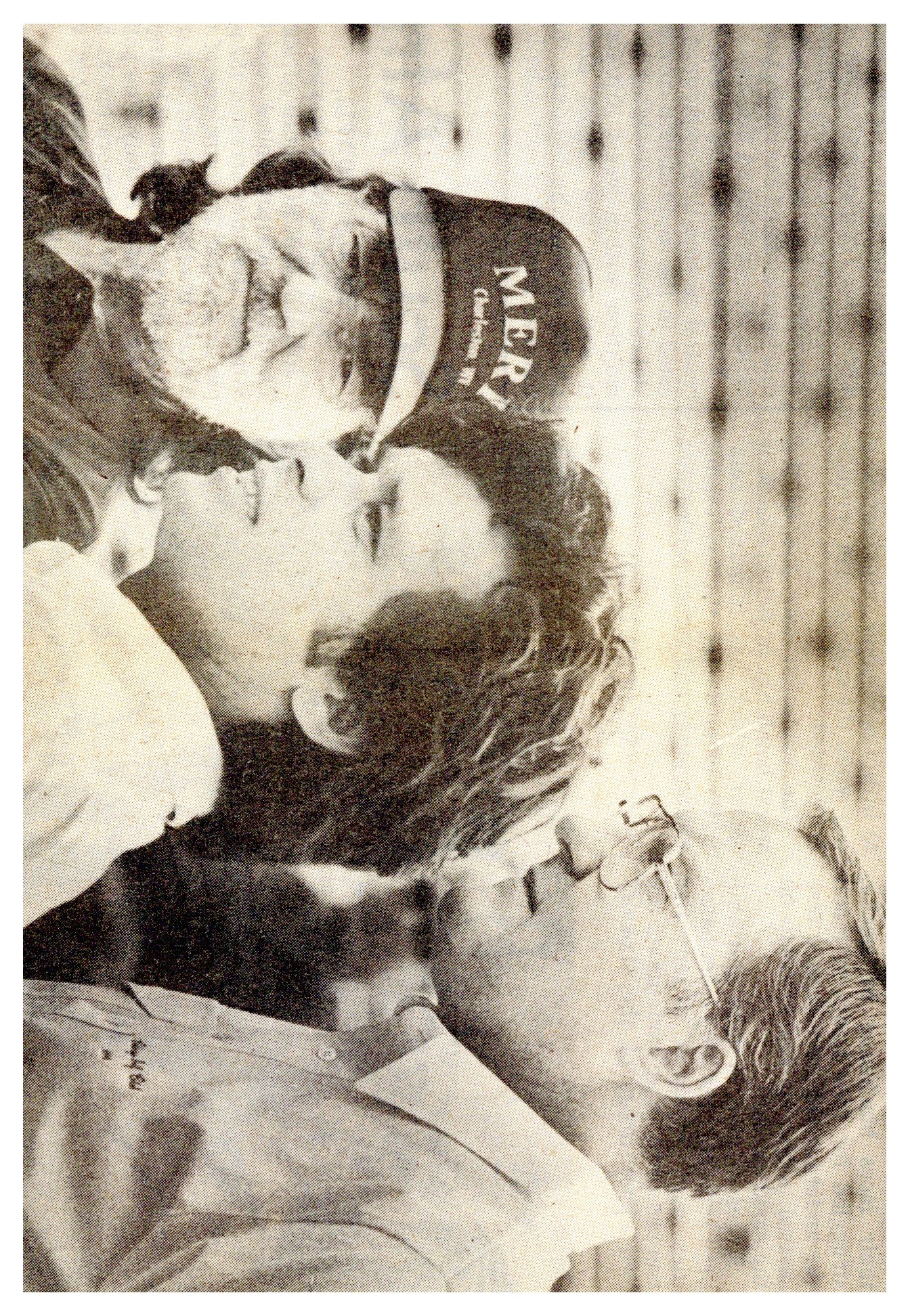 A black and white photograph of Willie Nelson (left), John Mellencamp (center), and Governor James Thompson (right) at Farm Aid in 1985.