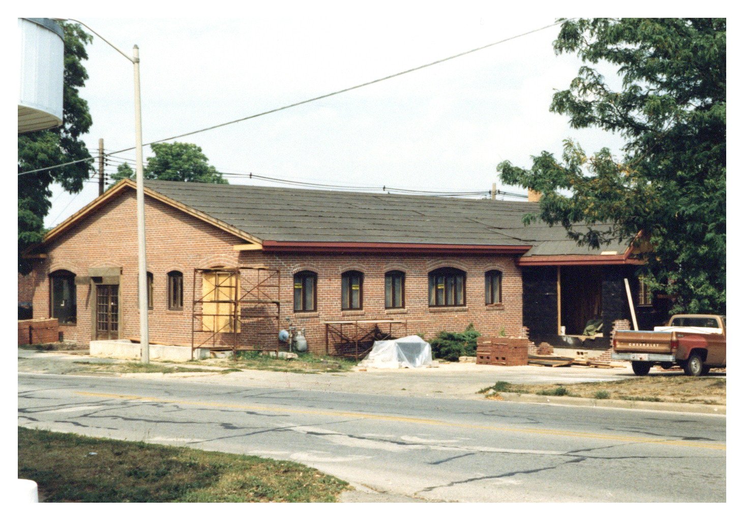 A color photograph of a brick building under construction.