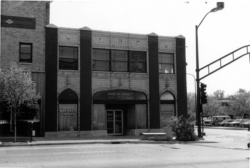 A black and white photograph of the Knowlton and Bennett building taken from across the street, taken circa 1990.