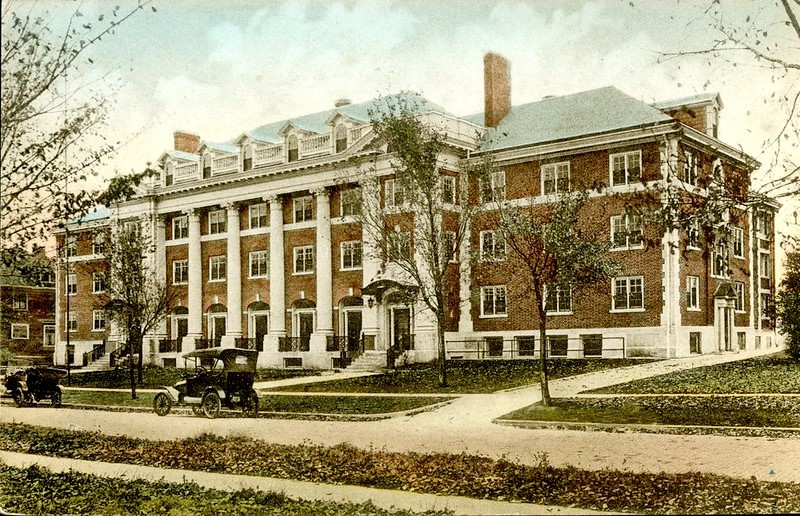 A color postcard of Busey Hall, a brick colonial building with white columns.