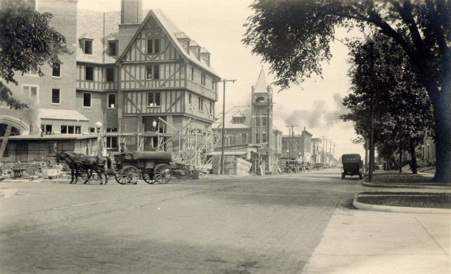 Black and white photograph of the Urbana Lincoln Hotel during construction in 1923. A horse and carriage are visible in front of the building.