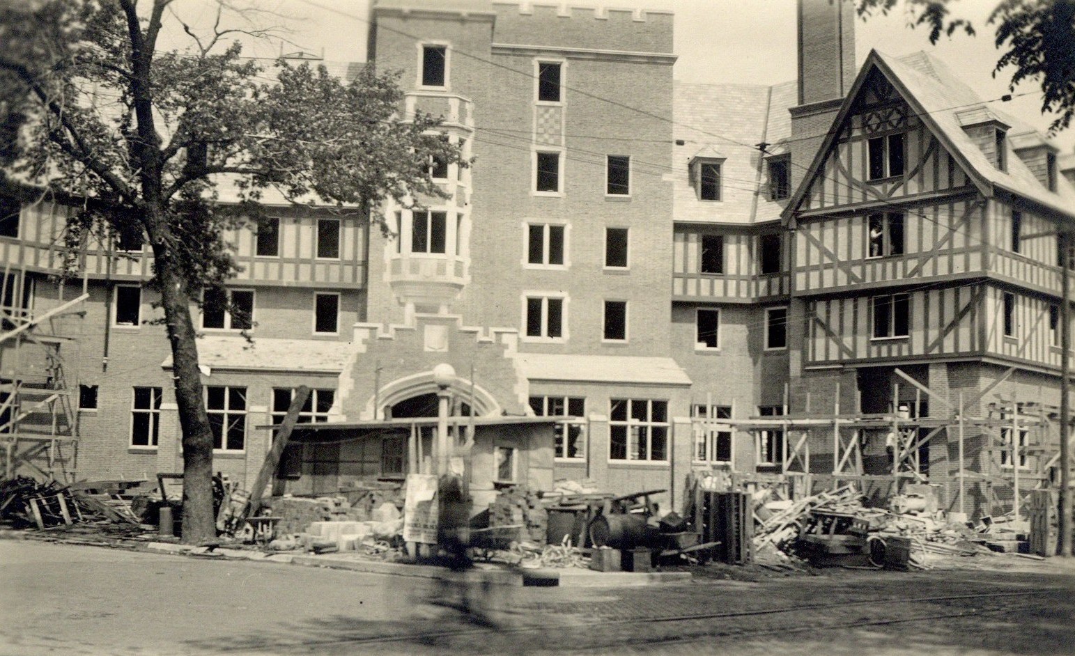 Black and white photograph of the Urbana Lincoln Hotel during construction in 1923. Construction materials and scaffolding are visible in front of the hotel.