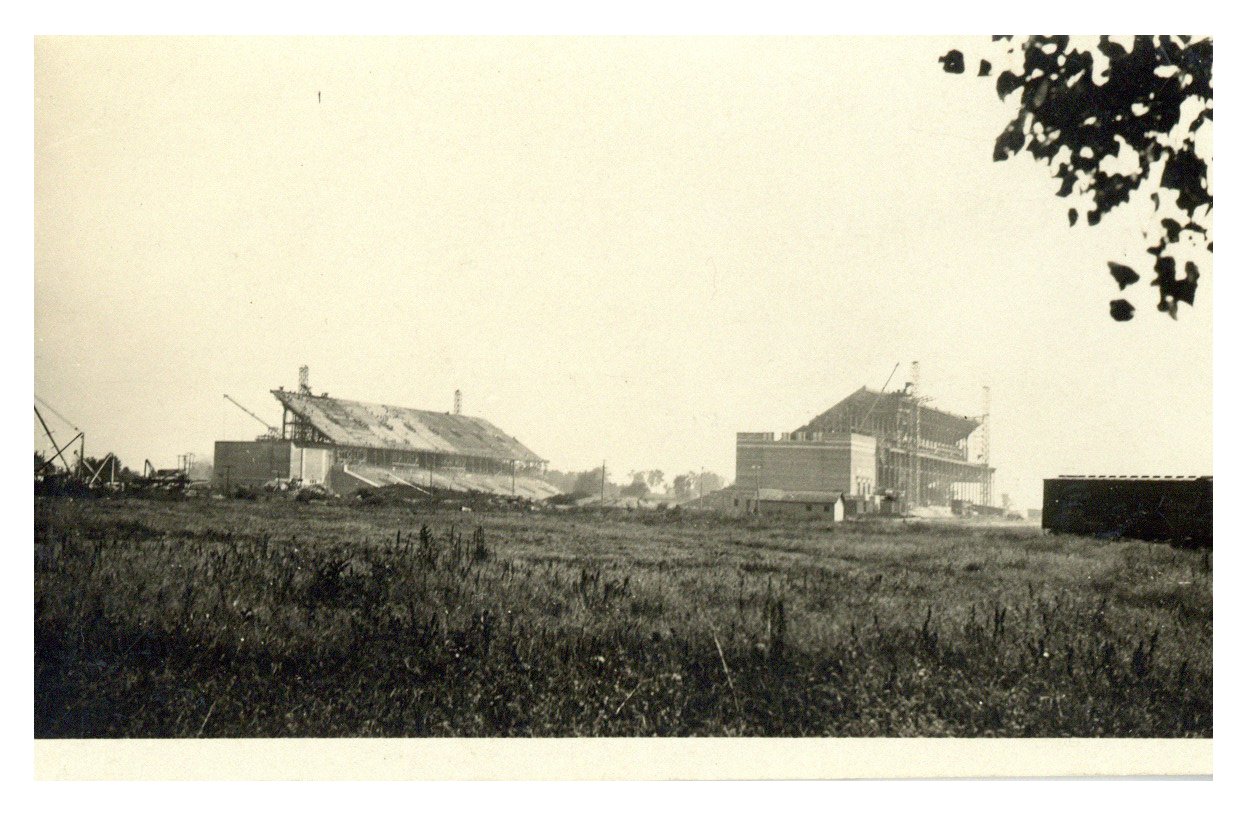 A black and white photograph of Memorial Stadium under construction in the distance, taken in 1923.