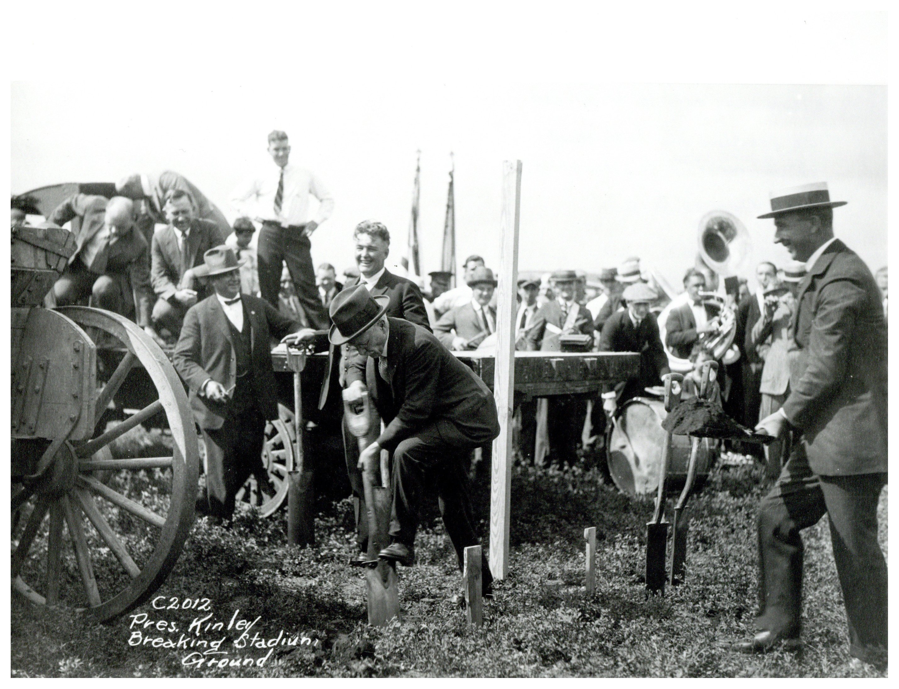 A black and white photograph of the groundbreaking of Memorial Stadium. Men stand around with shovels.