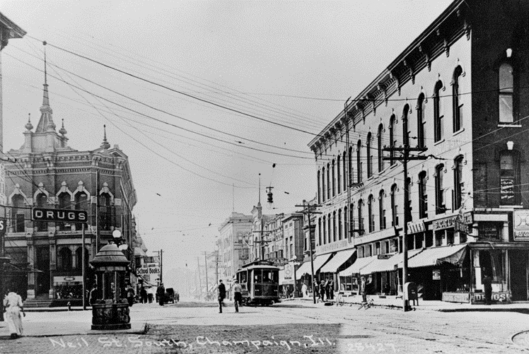 Black and white photograph of the intersection of Neil and East Main Streets.