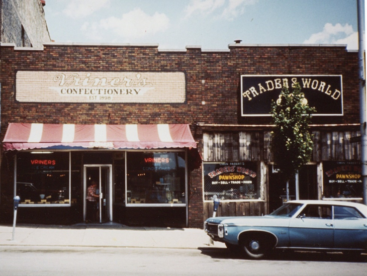 A color photograph of the facades of Vriner's Confectionery and Traders World.