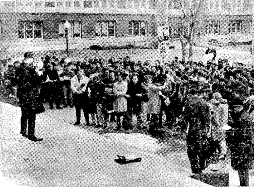 Students join hands and sing “We Shall Overcome” on the steps of the Auditorium, March 13th, 1965, from The Daily Illini, Illinois Digital Newspaper Collection.