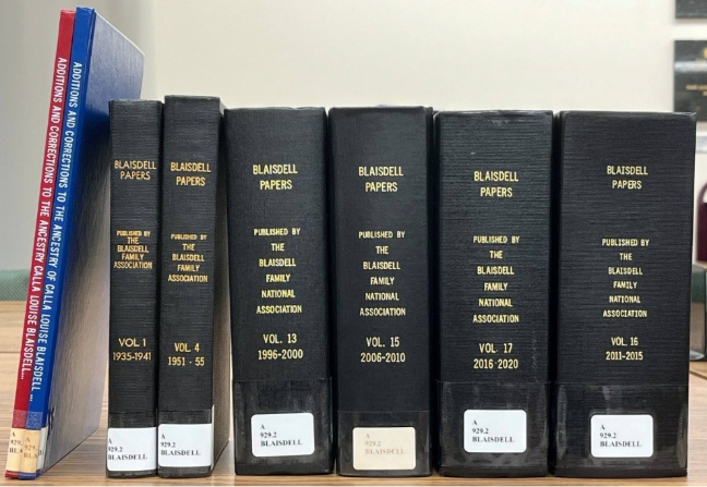 A row of black books
AI-generated content may be incorrect.