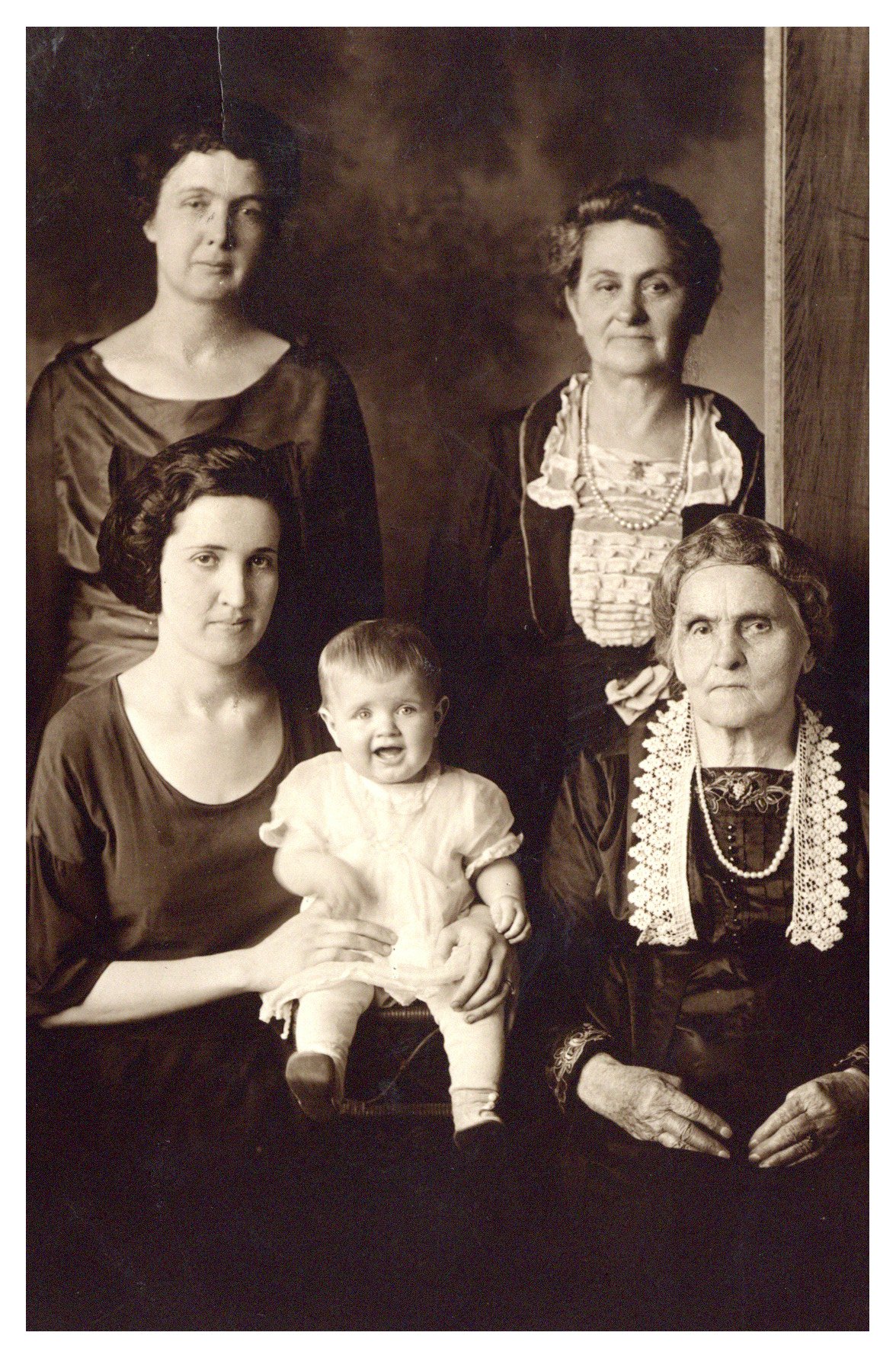 Five generations of women in one photograph. They are positioned in order of age, oldest to youngest, counter clock-wise from the lower right.