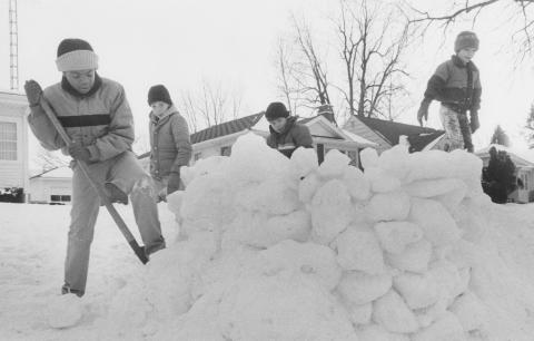 Kids building snow fort.