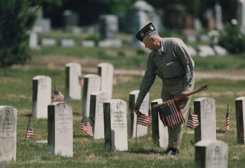 Dick Stillwell decorating graves of veterans in Mount Hope Cemetery, News-Gazette 30 May 1993 