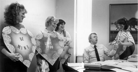 Members of the First Christian Church of Champaign deliver a singing valentine to Dan Demko in his office at the Southland Distribution Center, Champaign. 1985