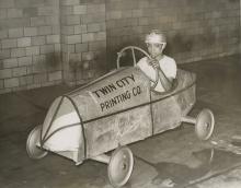 Boy in soap box derby car