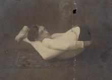 Walter C. Glines, ca. 1910, in a contorted position, legs behind his head