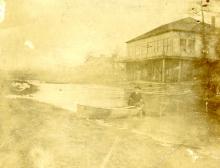 Man in canoe by boathouse on Crystal Lake, 1901
