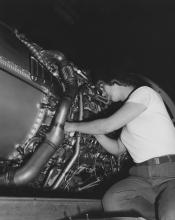 Woman working on jet engine